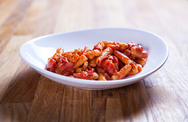 Rigatoni paste in tomato sauce with onion and vegetable. Red sos Penne pasta. Fresh food. Fres italian dish. Italian kitchen.