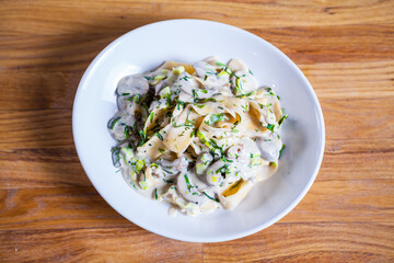 Tagliatelle pasta with asparagus mushrooms and basil in sour cream sauce. Italian pasta. fresh pasta 
culinary recipe