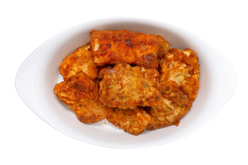 Fried cod fillets cut into squares lying on a white plate, isolated on a white background with a clipping path, top view.