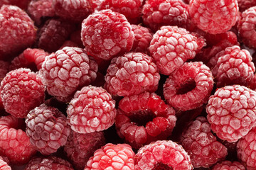 Frozen raspberries covered with hoarfrost. Berries background.
