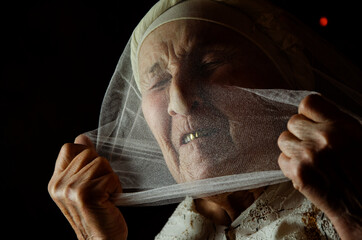 Old grandmother close up. The woman is under pressure. Work hard. Isolation concept. Search for...