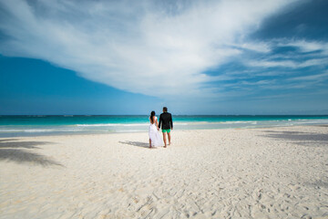 a newly married couple on the beach. a couple on the honeymoon on the beach