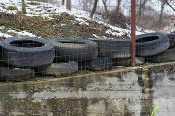 old tires placed near the fence