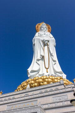 China, Sanya – January 21, 2020: Guan Yin of the South Sea of Sanya statue againct blue sky in Nanshan Buddhism Cultural Centre.