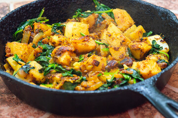 Saag Aloo, Indian style spinach and potatoes in cast iron pan