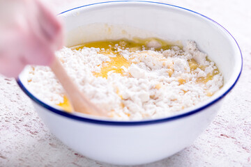 Making a shortcrust pastry adding melted butter to the flour