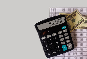 the word INCOME on the calculator, documents and dollars are next to it. Business and tax concept. Tax concept of the new 2021