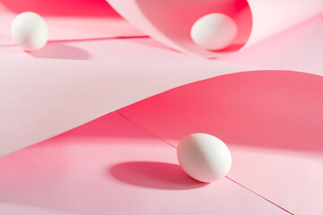 Pink pastel easter eggs with wave paper pink background