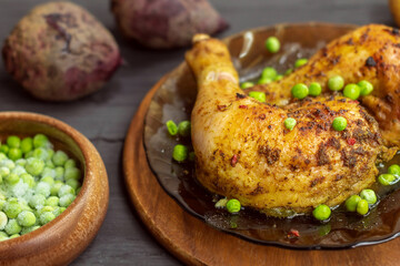 Chicken meat, cooked at home, lies on a plate with green peas
