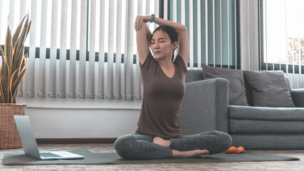 Slim fit Asian woman  Internet coach yoga and meditation coaching videos make them feel relaxed,...