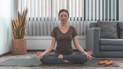 Slim fit Asian woman  Internet coach yoga and meditation coaching videos make them feel relaxed,...