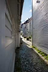 
White wooden walls of houses and stone pavement