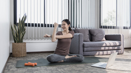 Slim fit Asian woman  Internet coach yoga and meditation coaching videos make them feel relaxed,...