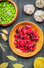 Light vegetarian salad of boiled beetroot on a wooden round plate
