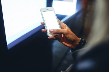 Anonymous woman using cellphone in street
