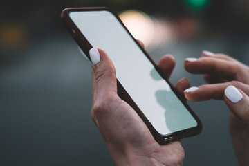 Faceless female messaging on smartphone