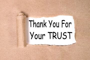 Thank you for your trust. text on white paper over torn paper background.