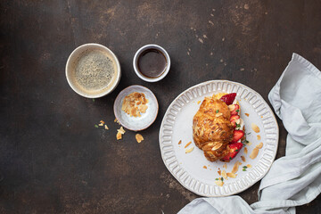 Croissant sandwich with camembert cheese   and strawberry 