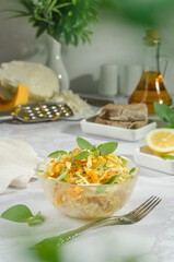 Cabbage salad, grated carrots and pumpkin with butter, basil and rosemary herbs