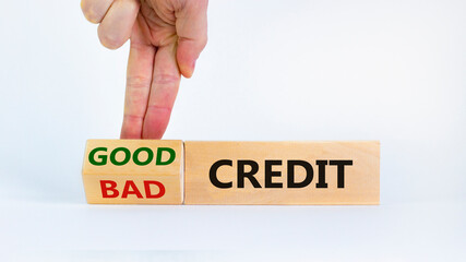 Good or bad credit symbol. Businessman turns cubes and changed words 'bad credit' to 'good credit'....