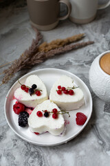 Panna Cotta with fresh berries on white plate. Delicious homemade dessert as tasty breakfast