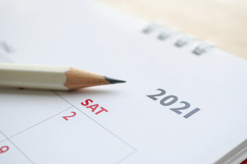 white pencil on 2021 calendar background business planning appointment meeting concept
