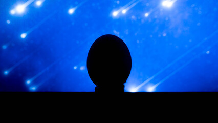 Silet, egg oval, on a blue background. A place for text. Unusual egg