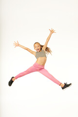 Fototapeta na wymiar Cheerful cute girl jumping and screaming with joy