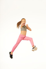 Adorable girl fighter jumping and punching air