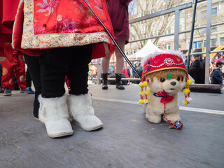 USA, Washington State, Seattle. Girl with stuffed dog in contest at Chinese New Year celebration in...