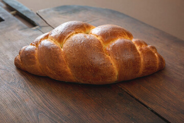 Easter tsoureki braid, greek easter sweet bread, on wooden background