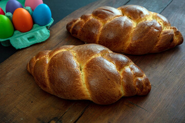Easter eggs and tsoureki braid, greek easter sweet bread, on wooden background