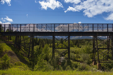 Old wooden railroad bridge with blue sky background