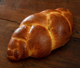 Easter tsoureki braid, greek easter sweet bread, on wooden background