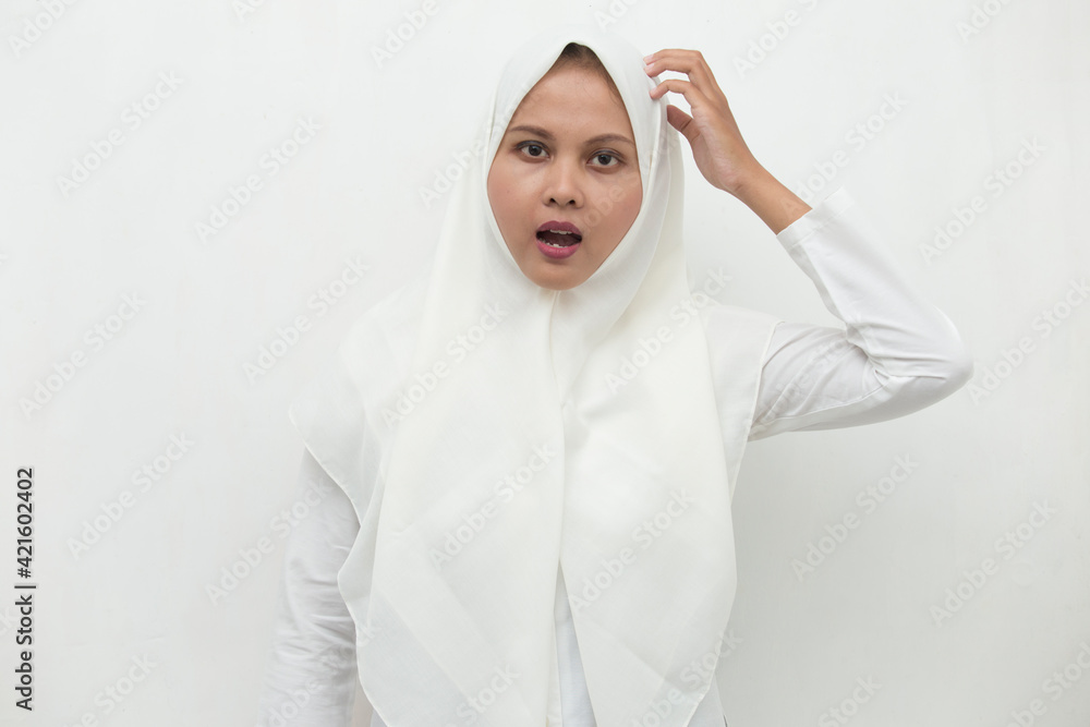 Wall mural portrait of a young asian muslim woman confused