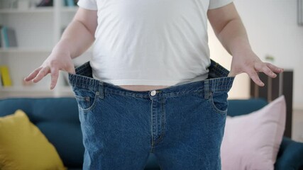 Male wearing oversize jeans, weight loss program, health care, metabolism