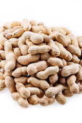 Peanuts in shells. Pile of raw peanuts in shells. Organic peanuts in shell isolated on white background. Heap of peanut closeup.