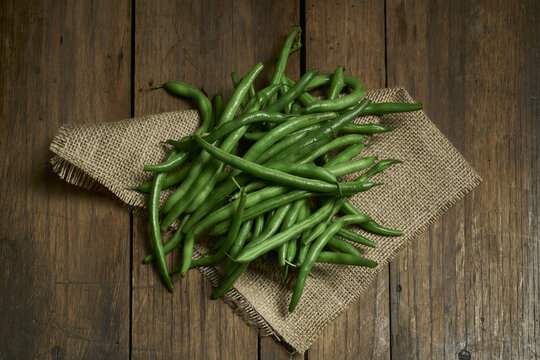 Overhead Shot Of Green Beans On A Wooden Table