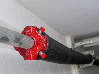 Electric garage door opener coiled tension spring.