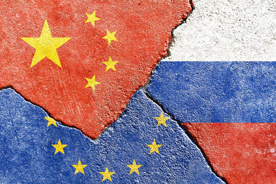 View of China Russia EU flags icon on weathered cracked wall background