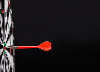 Red dart arrow on center of dartboard. Concept o business target, success and win.