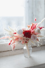 Bright trendy composition of dried flowers, home decor, a long-lasting gift of flowers and herbs