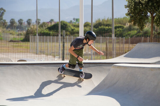 Teenage Hispanic boy skateboarding in a skateboard park