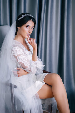 Morning of the bride. young girl in a white lace boudoir with a