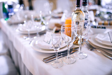 Wedding. Banquet. round table for guests, served with cutlery, crockery, covered with a white tablecloth.