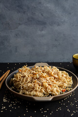 Sesame seed teriyaki dish with black sauce on black background