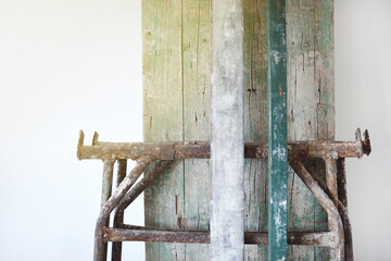 White wall with construction tools, scaffolding, and textured timbers