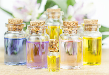 Set of colorful bottles with floral essential oil. Alternative medical concept.