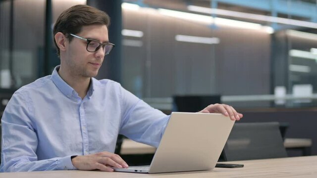 Young Man Closing Laptop and Going Away 