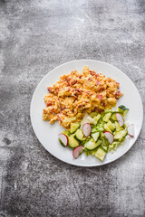 Fried eggs with vegetables on white plate. Healthy food
